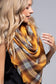 blond girl wearing yellow and brown plaid scarf