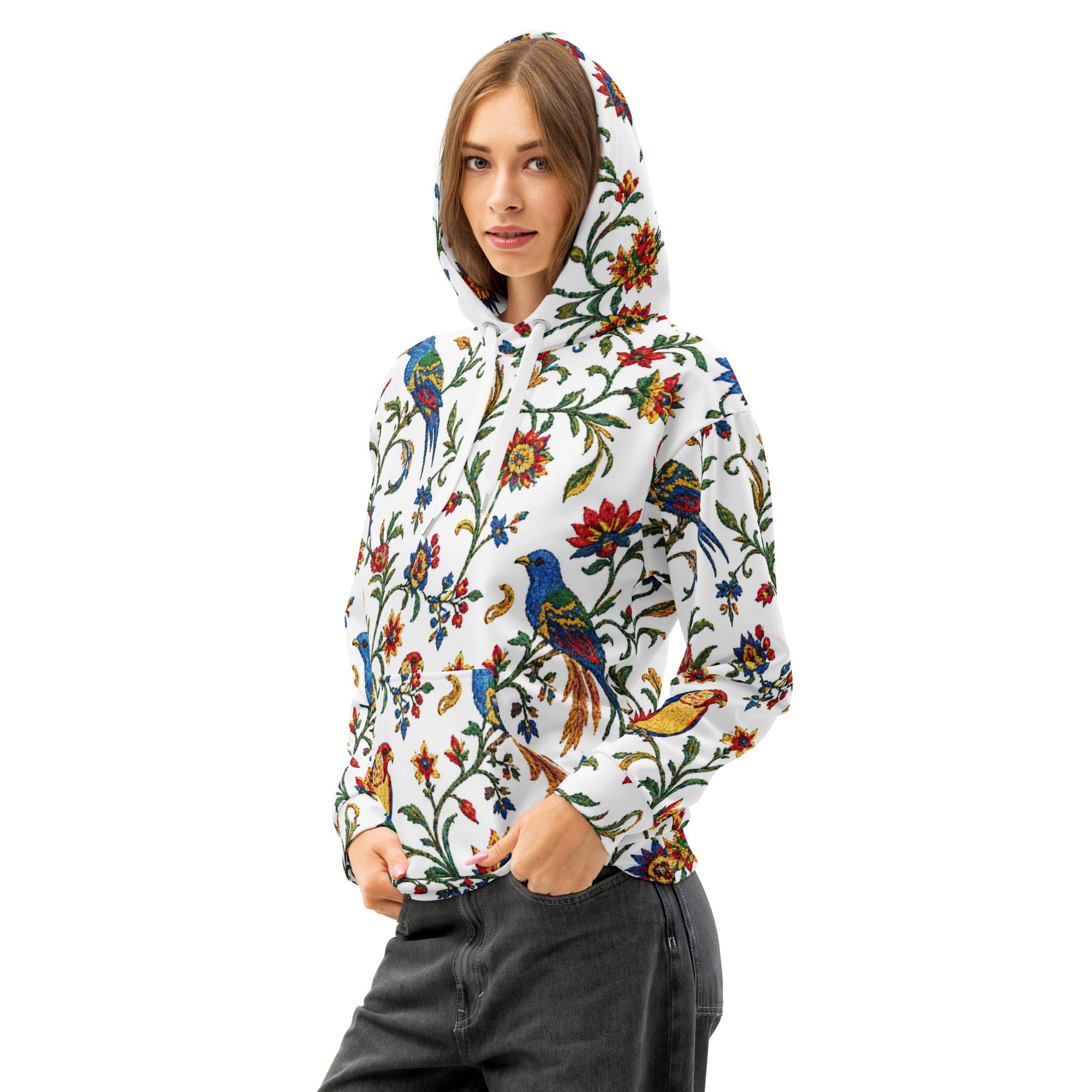 Person wearing a colorful floral and bird hoodie on a white background