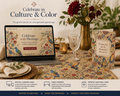 Table setting with laptop, flowers, and greeting card on a floral tablecloth.