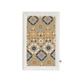 A rectangular quilted baby blanket with a Southwestern geometric pattern, featuring a tan, blue, and white design with an off-white stitched border, shown on a plain white background.