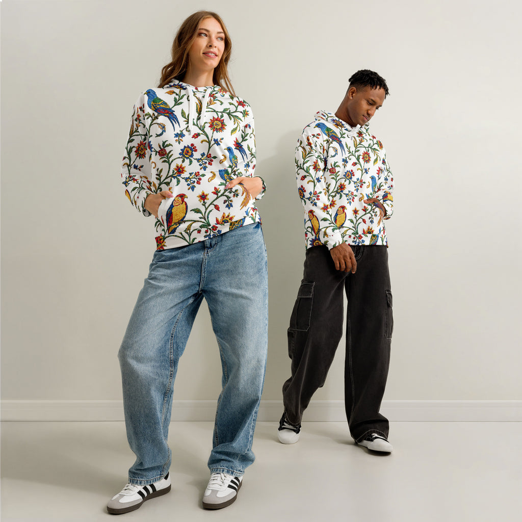 Two people wearing colorful floral-patterned hoodies against a plain background
