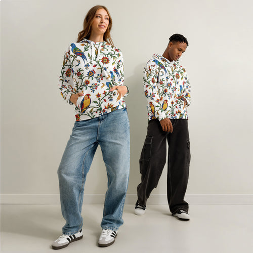Two people wearing colorful floral-patterned hoodies against a plain background